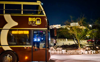 Big Bus Athens night tour with Acropolis view in the background.