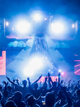 Crowd enjoying a vibrant light show at Amnesia nightclub in Ibiza.