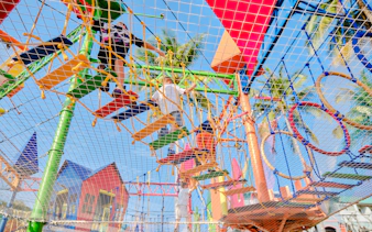 Children playing on a colorful adventure playground in Phuket during a 3.5-hour birthday party.
