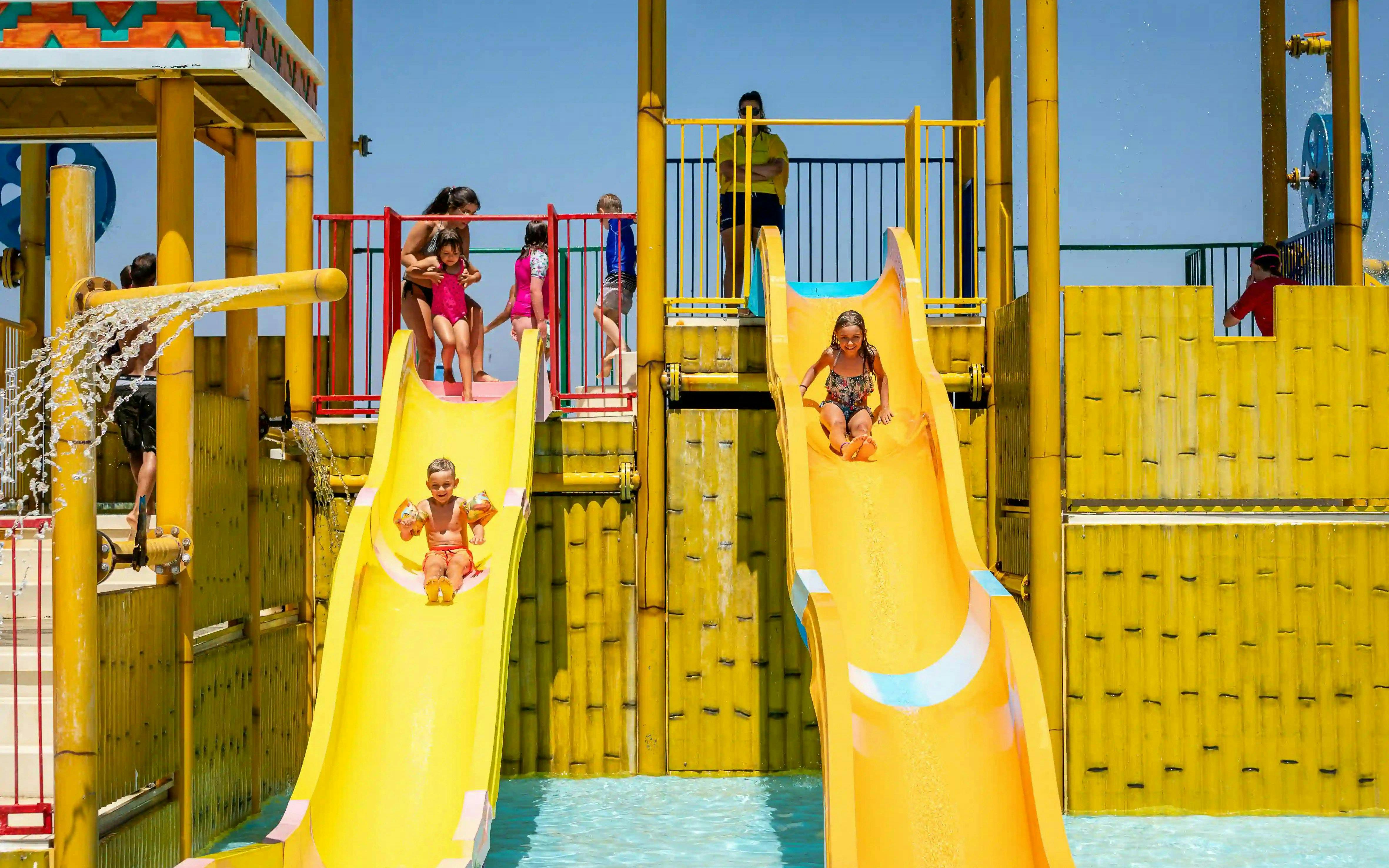 Children sliding down water slides at Aqualand Algarve's Children's Paradise.