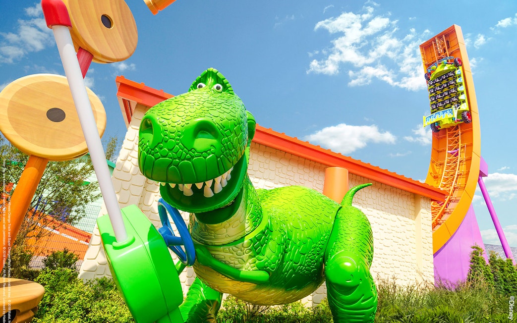 Rex's Racer ride in Toy Story Land, Shanghai Disneyland, featuring a large green dinosaur.