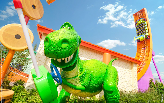 Rex's Racer ride in Toy Story Land, Shanghai Disneyland, featuring a large green dinosaur.
