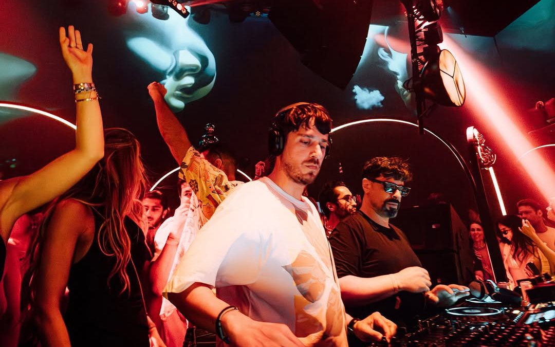DJ performing at Club Chinois, Ibiza with crowd enjoying the music.