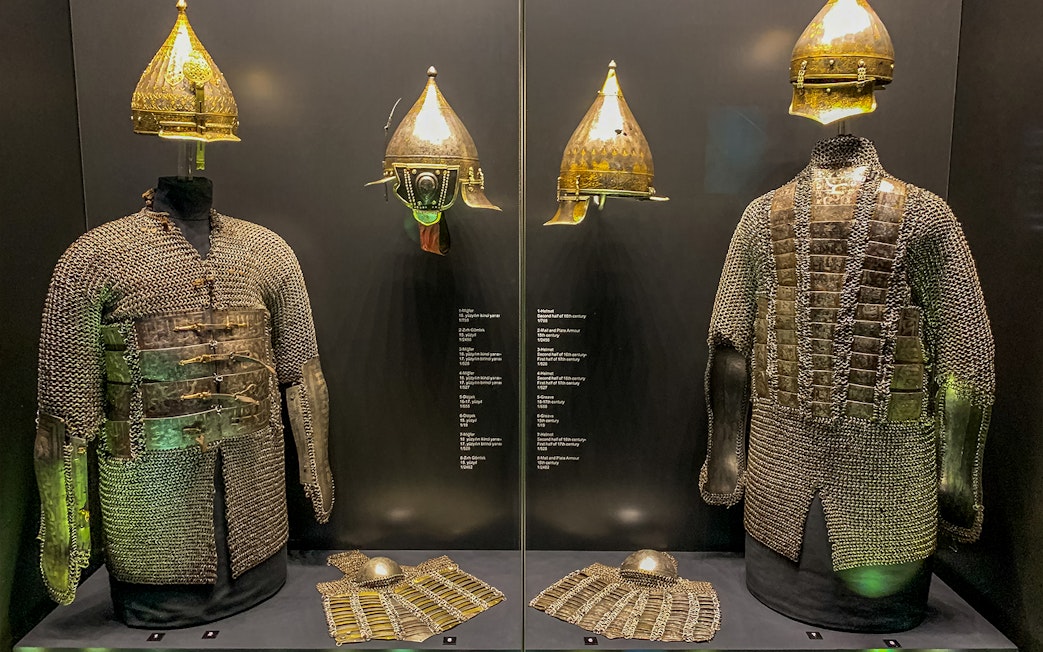 Armory display of chainmail and helmets at Topkapi Palace's Imperial Treasury in Istanbul, Turkey.