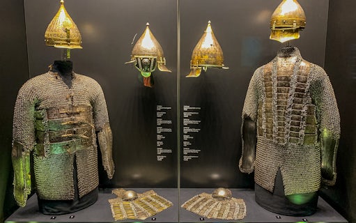 Armory display of chainmail and helmets at Topkapi Palace's Imperial Treasury in Istanbul, Turkey.