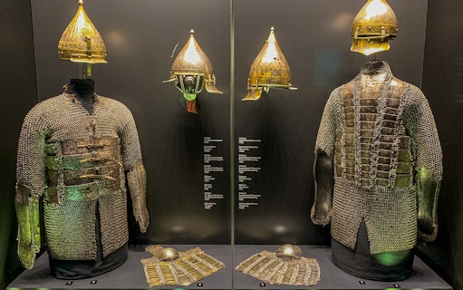 Armory display of chainmail and helmets at Topkapi Palace's Imperial Treasury in Istanbul, Turkey.