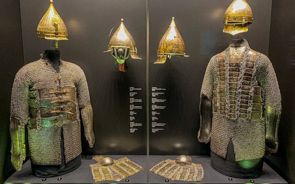Armory display of chainmail and helmets at Topkapi Palace's Imperial Treasury in Istanbul, Turkey.