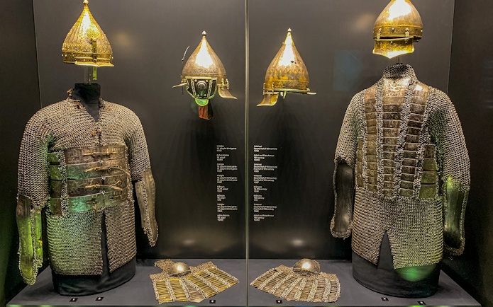 Armory display of chainmail and helmets at Topkapi Palace's Imperial Treasury in Istanbul, Turkey.