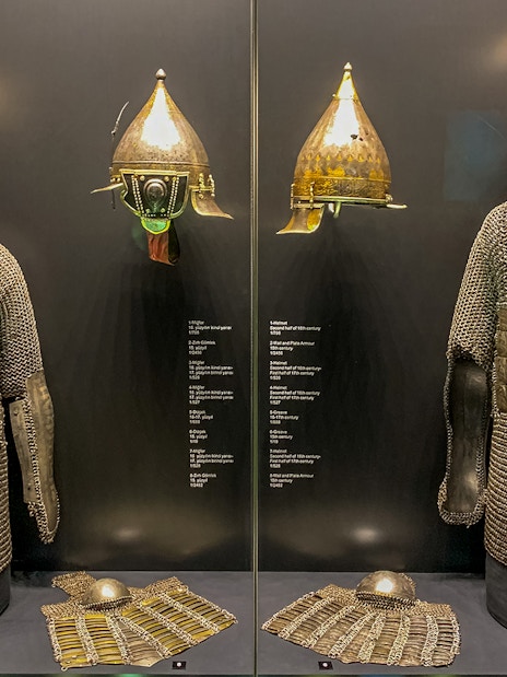 Armory display of chainmail and helmets at Topkapi Palace's Imperial Treasury in Istanbul, Turkey.