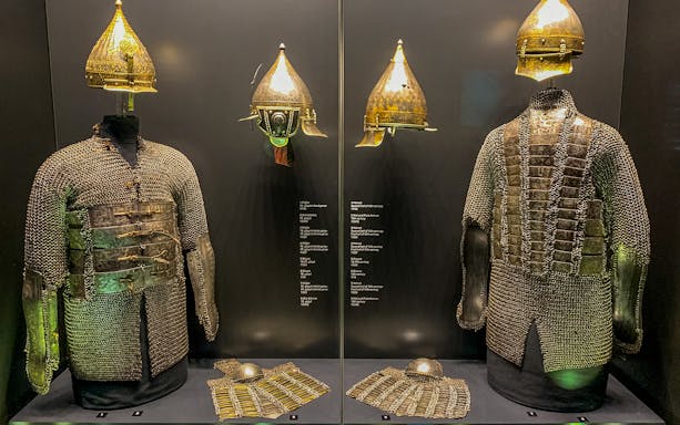 Armory display of chainmail and helmets at Topkapi Palace's Imperial Treasury in Istanbul, Turkey.