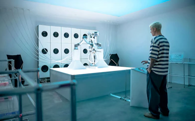 Robotic arm playing cello at Mercer Labs Museum of Art exhibit.