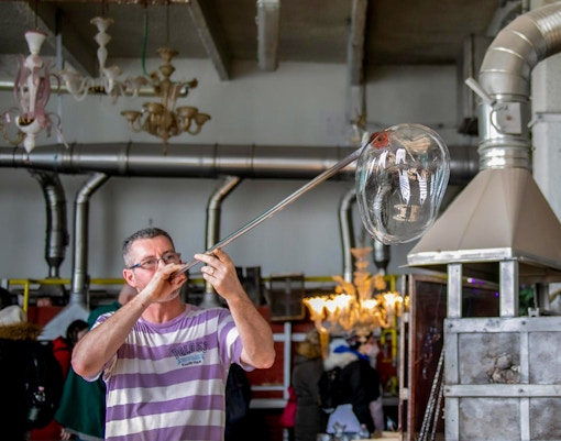Murano Glass Factory artisans crafting intricate glass art in Venice, Italy.
