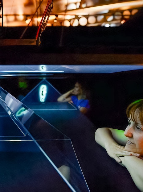 Visitors observing holographic display at Valencia Science Museum, part of Oceanogràfic and Hemisfèric combo tickets.