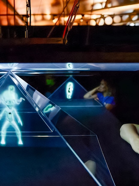 Visitors observing holographic display at Valencia Science Museum, part of Oceanogràfic and Hemisfèric combo tickets.