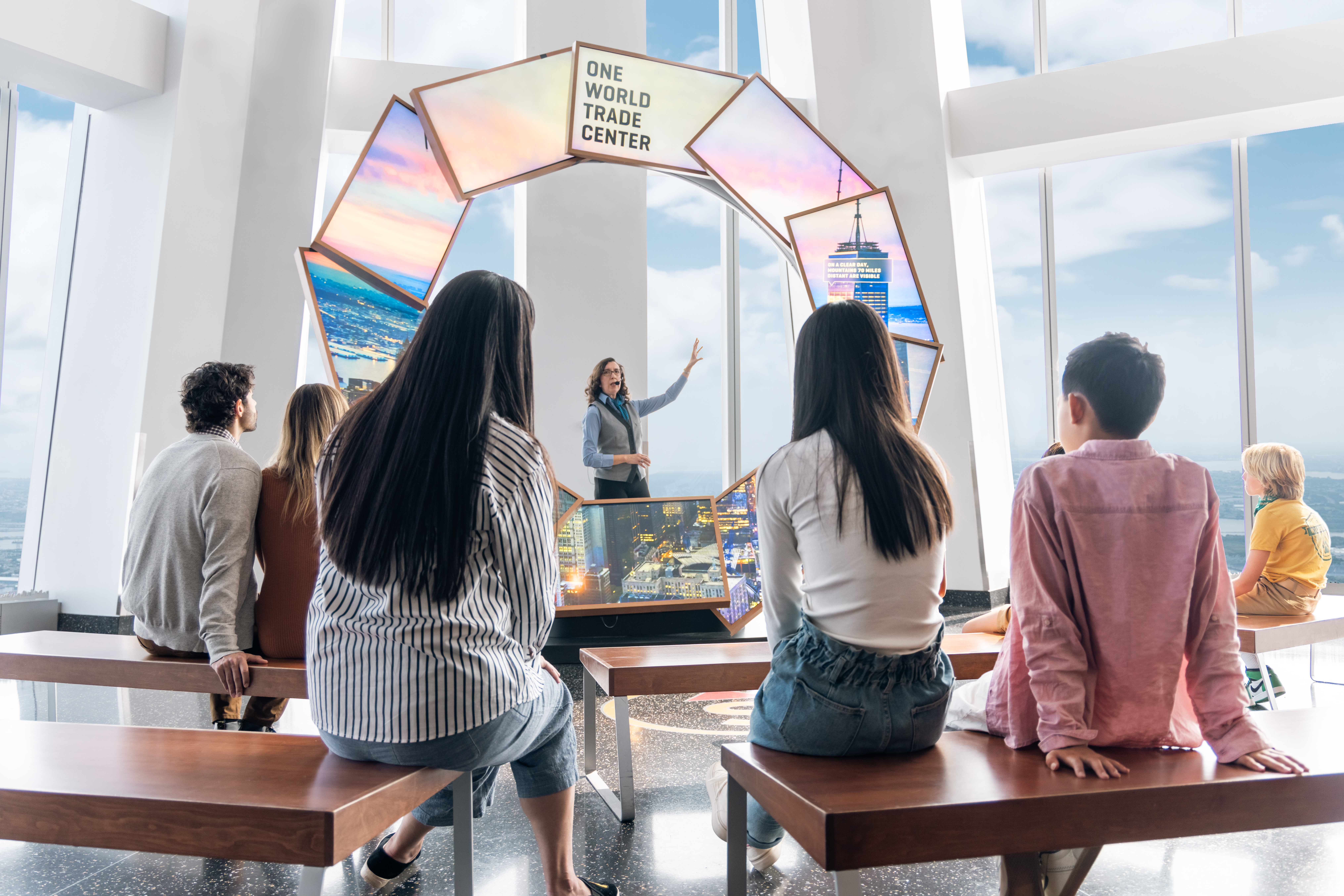 Visitors listening to a guide at One World Observatory, New York City.