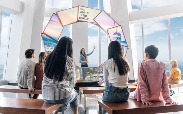 Visitors listening to a guide at One World Observatory, New York City.