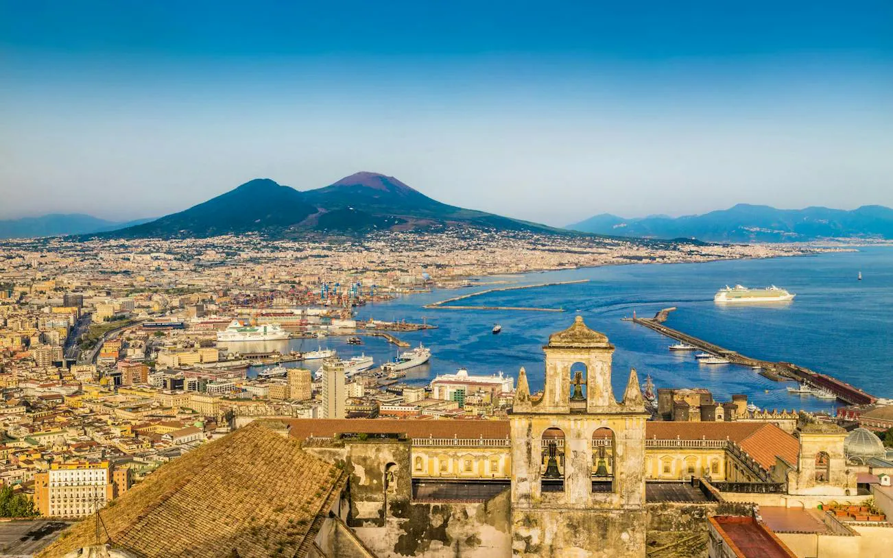Naples cityscape with Mount Vesuvius and harbor, part of Cazzimma self-guided exploration game.