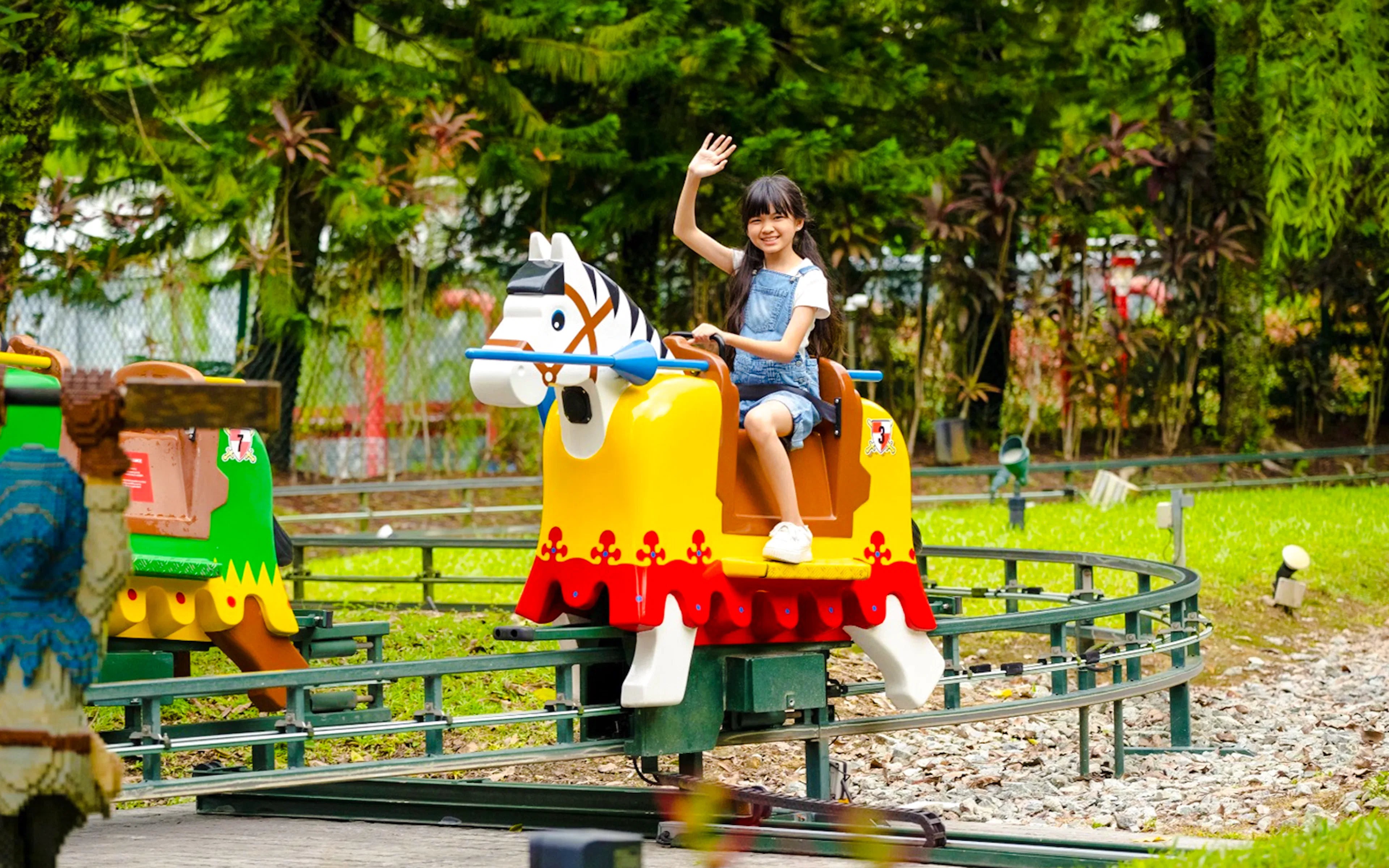 Child enjoying a ride at Lego Kingdoms in Legoland Malaysia.