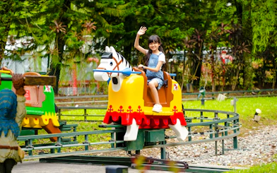 Child enjoying a ride at Lego Kingdoms in Legoland Malaysia.