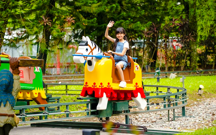 Child enjoying a ride at Lego Kingdoms in Legoland Malaysia.