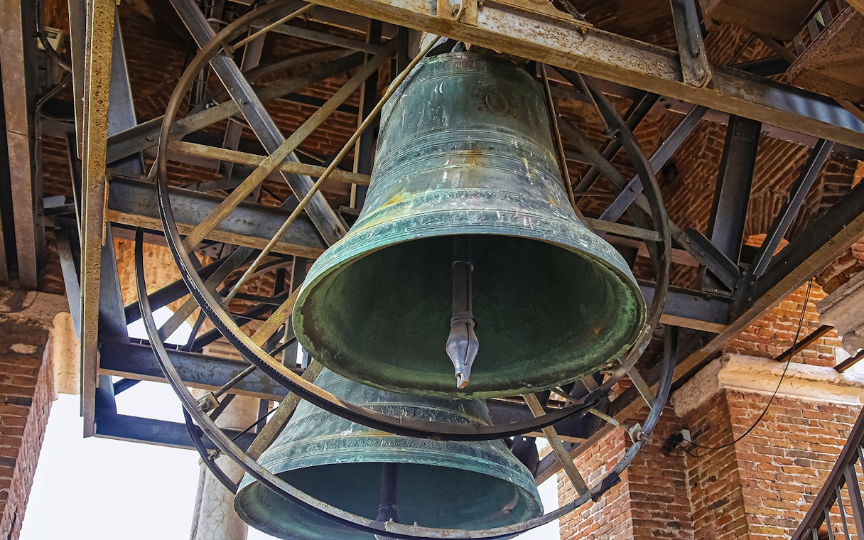 Bells inside Mark’s Bell Tower, Venice, showcasing intricate metalwork.
