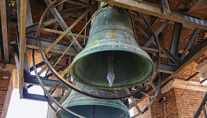Bells of Mark’s Bell Tower in Venice, Italy, showcasing intricate metalwork and historical architecture.