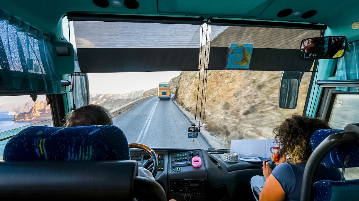 Tour bus on winding road from Thera to cruise port, Santorini, Greece.
