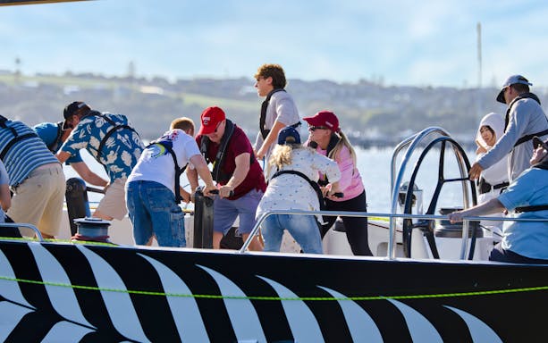Participants sailing on Waitemata Harbour during America's Cup experience in Auckland.