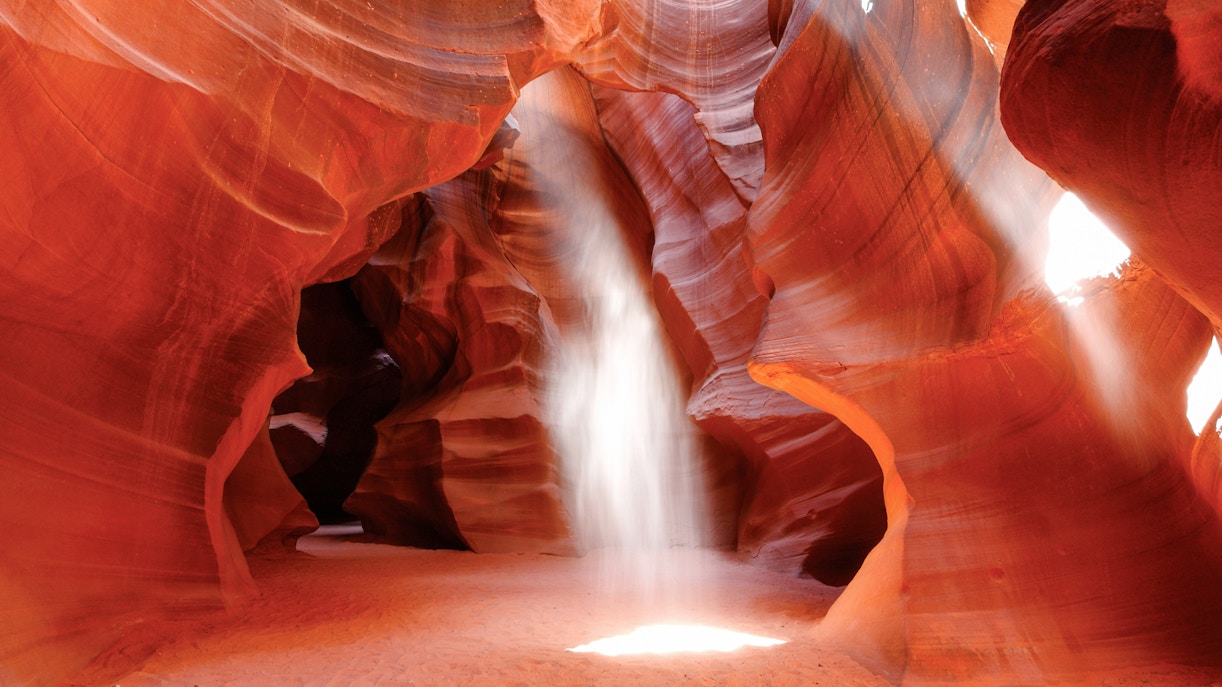 Sunbeam illuminating Upper Antelope Canyon's red sandstone walls, Page, Arizona.