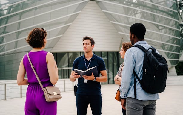 Guide with tourists at Fondation Louis Vuitton, Paris, France.