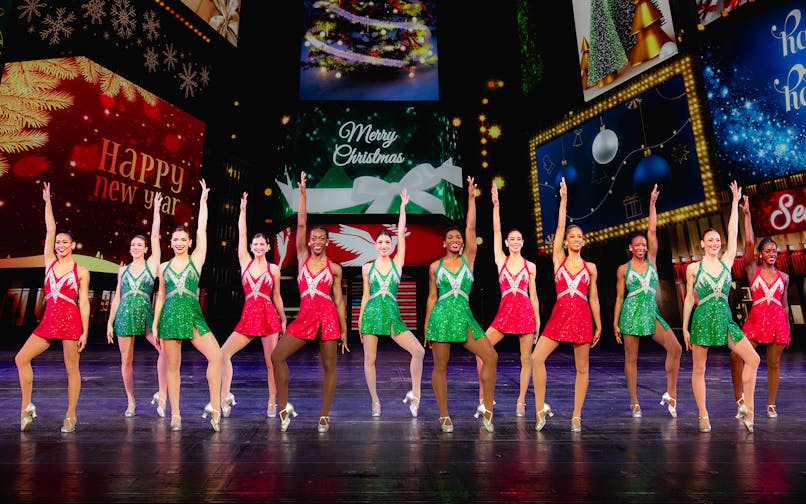 Radio City Rockettes performing in Christmas-themed costumes at the Radio City Christmas Spectacular.