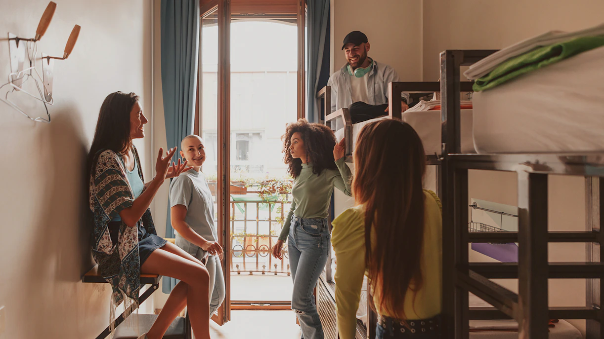 Group of people socializing in a dorm room at Generator Hostel, London’s theatre district.