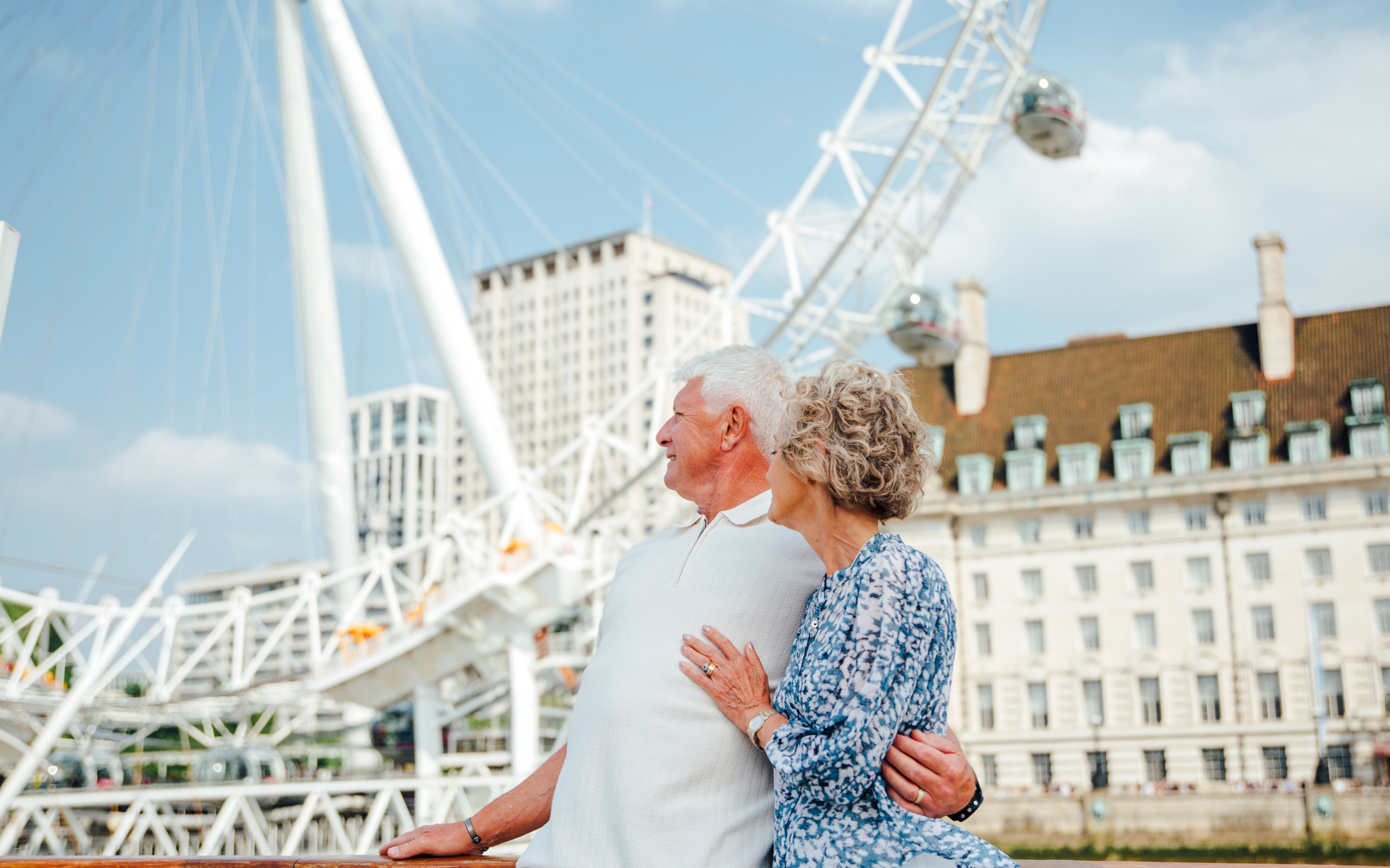 Guests enjoying the view of the London Eye from the Tower of London Cruise boat.