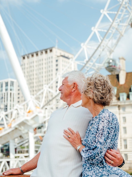 Guests enjoying the view of the London Eye from the Tower of London Cruise boat.