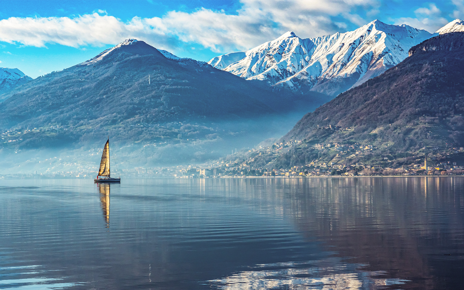 Snow-covered mountains and Lake Como in winter, Italy.
