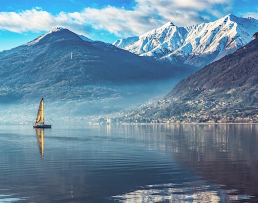 Snow-covered mountains and Lake Como in winter, Italy.