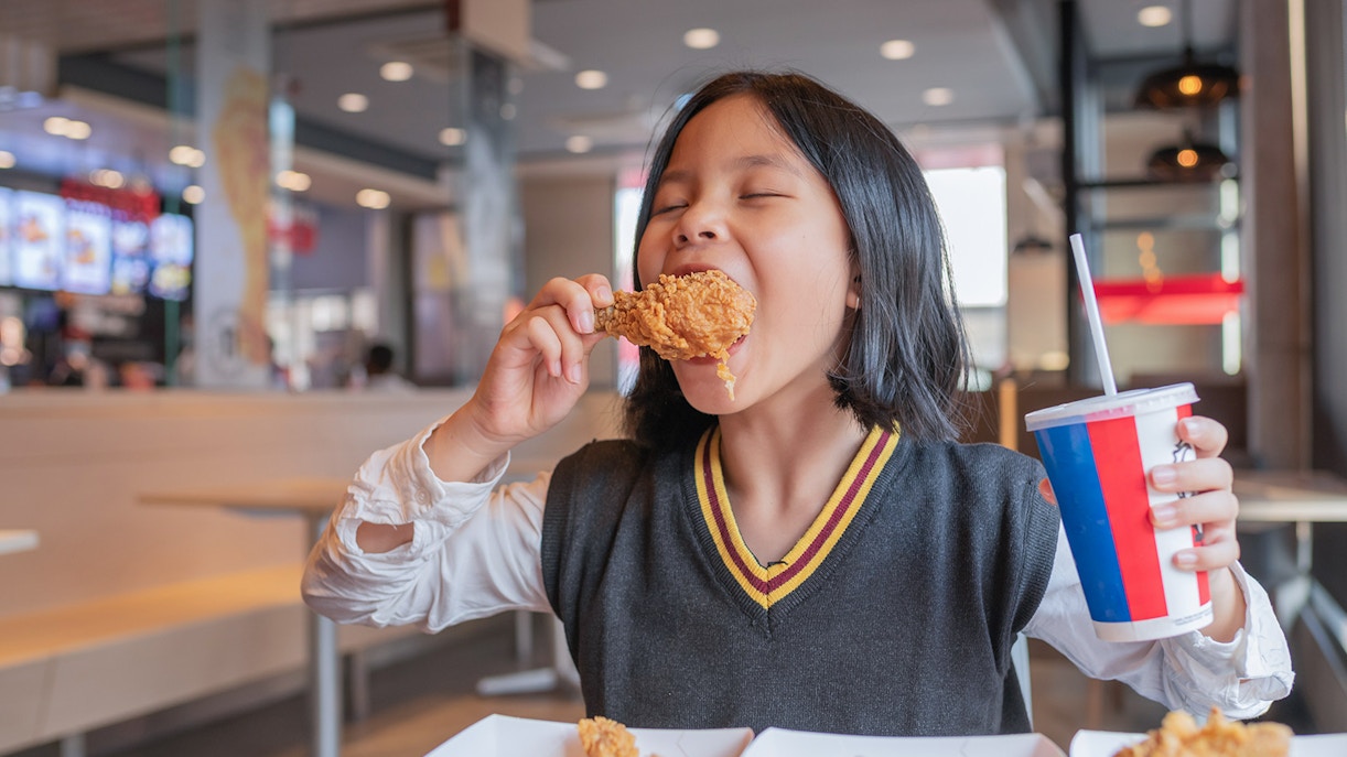 Kid eats KFC chicken