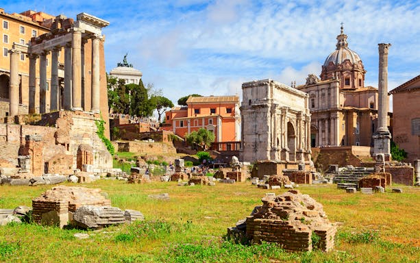 Palatine Hill ruins with ancient columns and arches in Rome, Italy.