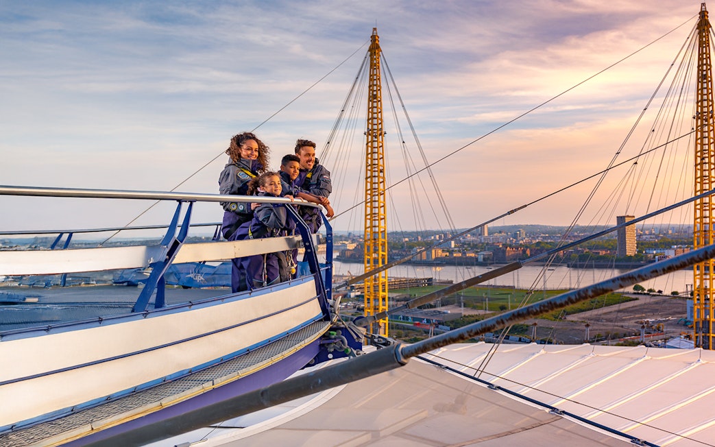 Guests enjoying the view from the O2 roof at sunset in London.