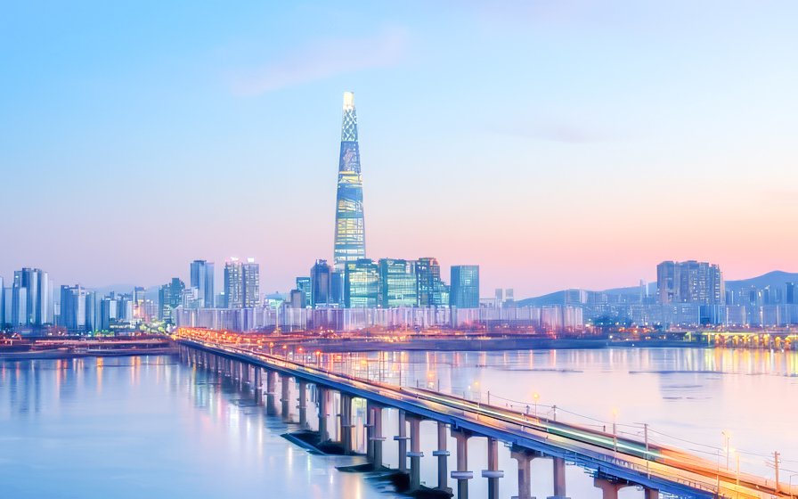 Seoul skyline and Lotte World Tower viewed from Han River during sunset cruise.
