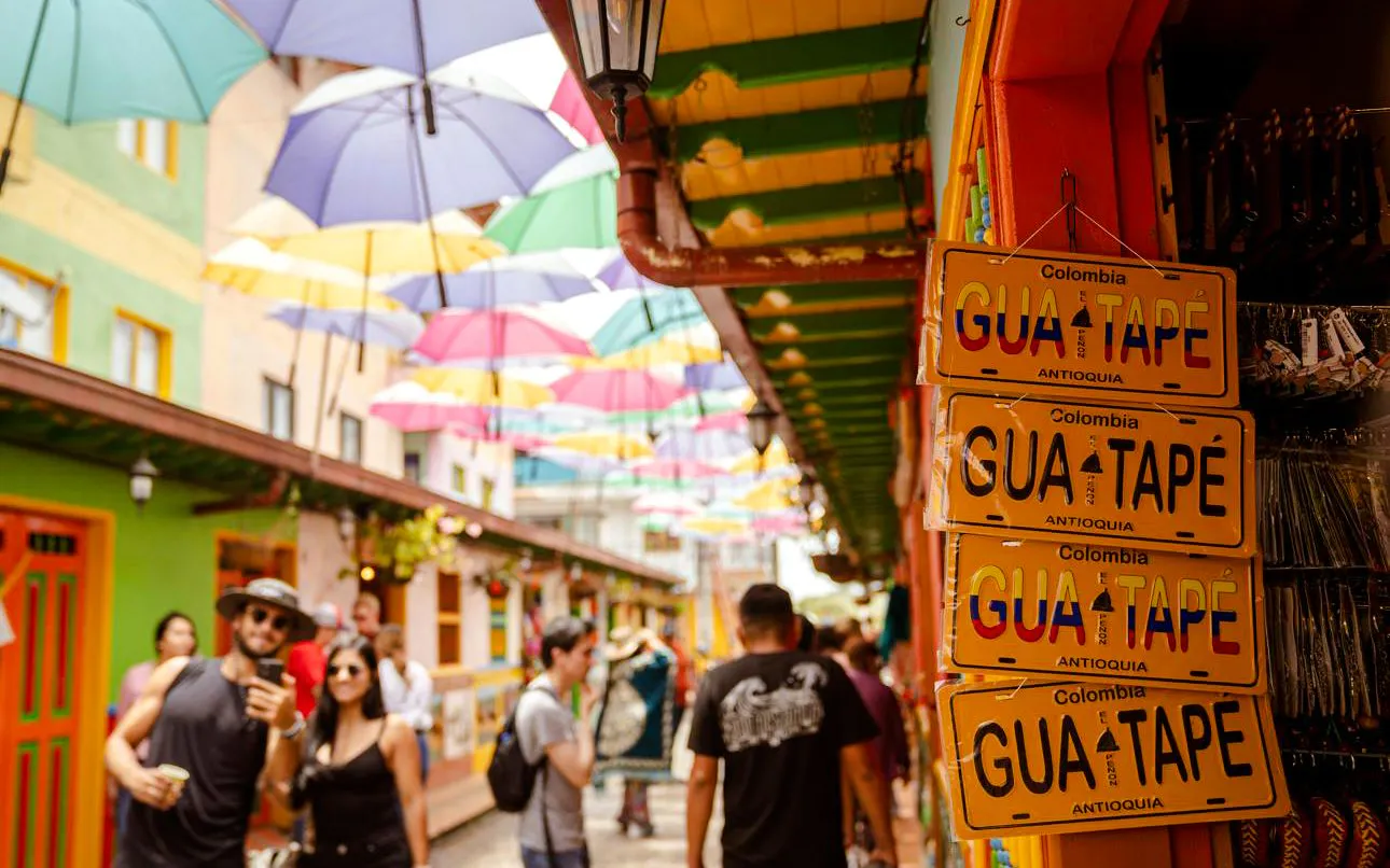 Colorful street with hanging umbrellas in Guatapé, Colombia.