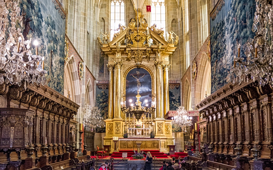 Wawel Cathedral interior with ornate altar and chandeliers, Krakow guided tour.
