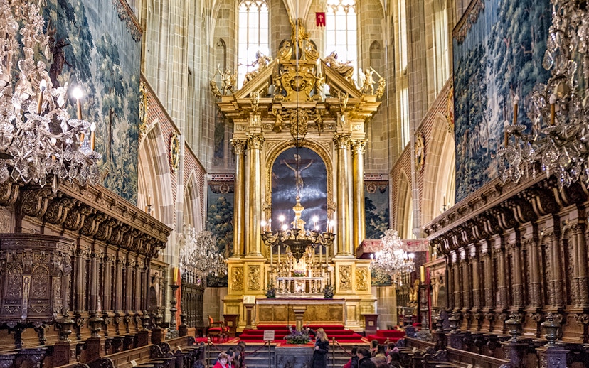 Wawel Cathedral interior with ornate altar and chandeliers, Krakow guided tour.