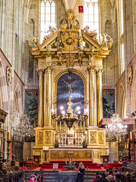 Wawel Cathedral interior with ornate altar and chandeliers, Krakow guided tour.
