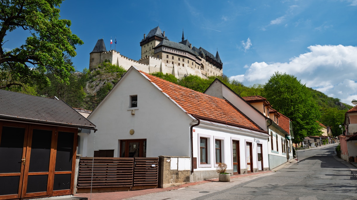 Czech houses with red tiled roofs below Karlstejn Castle.