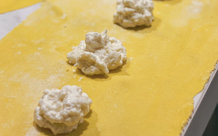 Ravioli filling on pasta sheet during masterclass near the Colosseum.