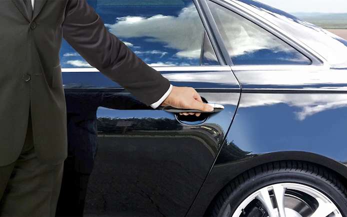 Private car door being opened for Tokyo airport transfer.
