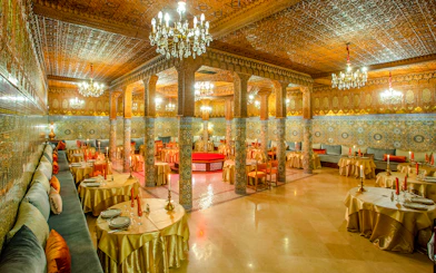 Dar Essalam Moroccan restaurant interior with ornate decor and candlelit tables.