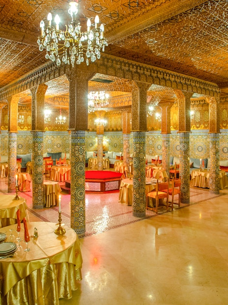 Dar Essalam Moroccan restaurant interior with ornate decor and candlelit tables.
