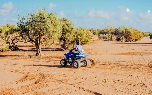 Quad biking through desert landscape near Agadir.